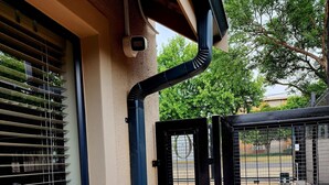 A building exterior with a window, a black metal gate, and a visible outdoor area. - 80 on Thabo (Potchefstroom)