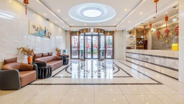 A modern hotel lobby with a reception desk, seating area, and a circular ceiling design. - Tingyue Yiju Hotel (Shanghai)