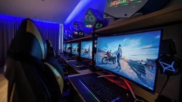 A gaming setup with multiple monitors, a keyboard, and a headset.