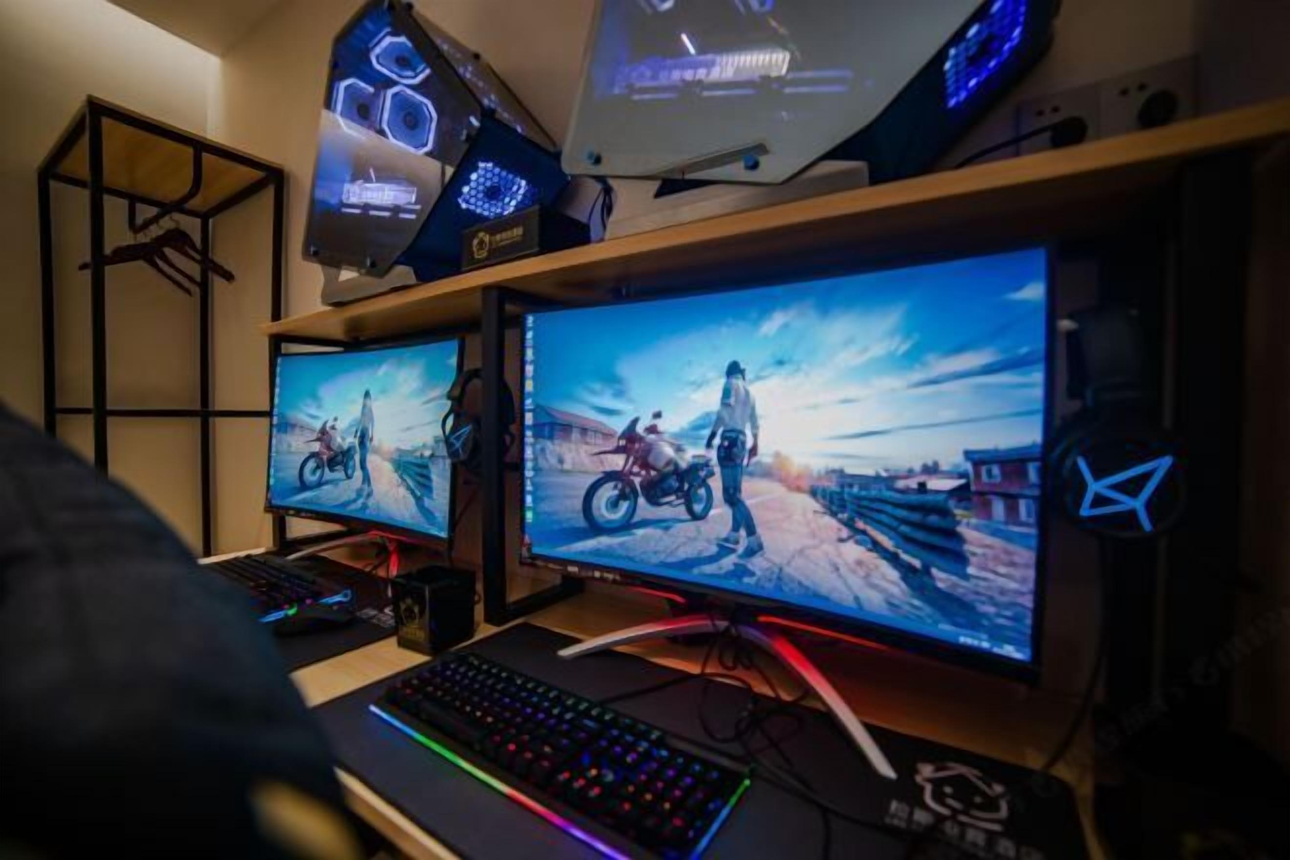 A gaming setup with two monitors, a keyboard, and a mouse.