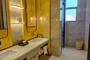 A modern bathroom with dual sinks, a large mirror, and a window providing natural light. - Taidong Fashion Island Hotel (Huizhou)
