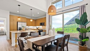 A modern kitchen with wooden cabinets, stainless steel appliances, and a large island. - Mauna View by AvantStay | 10min to Beach, Backyard (Oahu)
