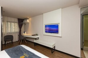 A hotel room with a bed, a desk with a chair, a television mounted on the wall, and a window with curtains. - Super 8 Hotel (Suzhou Jinfeng Road Subway Station Yushan Road) (Suzhou)