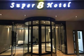 A hotel entrance with a revolving door and a sign that reads 'Super 8 Hotel'. - Super 8 Hotel (Suzhou Jinfeng Road Subway Station Yushan Road) (Suzhou)