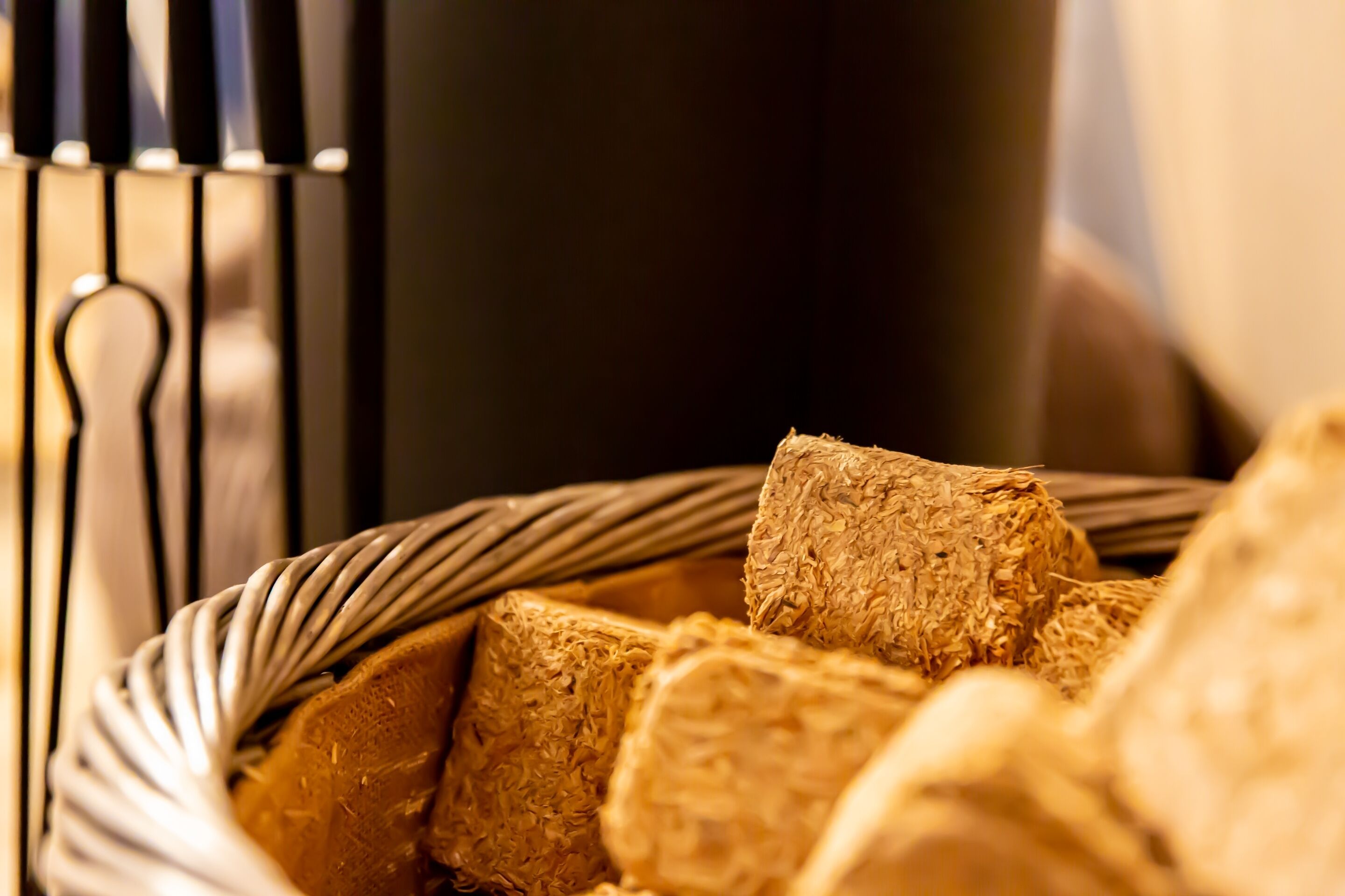 A basket filled with thick, textured bread rolls.