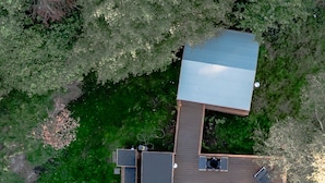 An aerial view of a house with a swimming pool, deck, and outdoor furniture. - Luna Domes (Edenbridge)