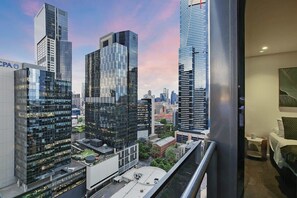 A high-rise hotel room with a cityscape view, modern architecture, and a balcony. - Southbank 2BR Apt City Views, Free Parking (Southbank)