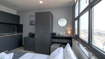 Desk, iron/ironing board, bed sheets