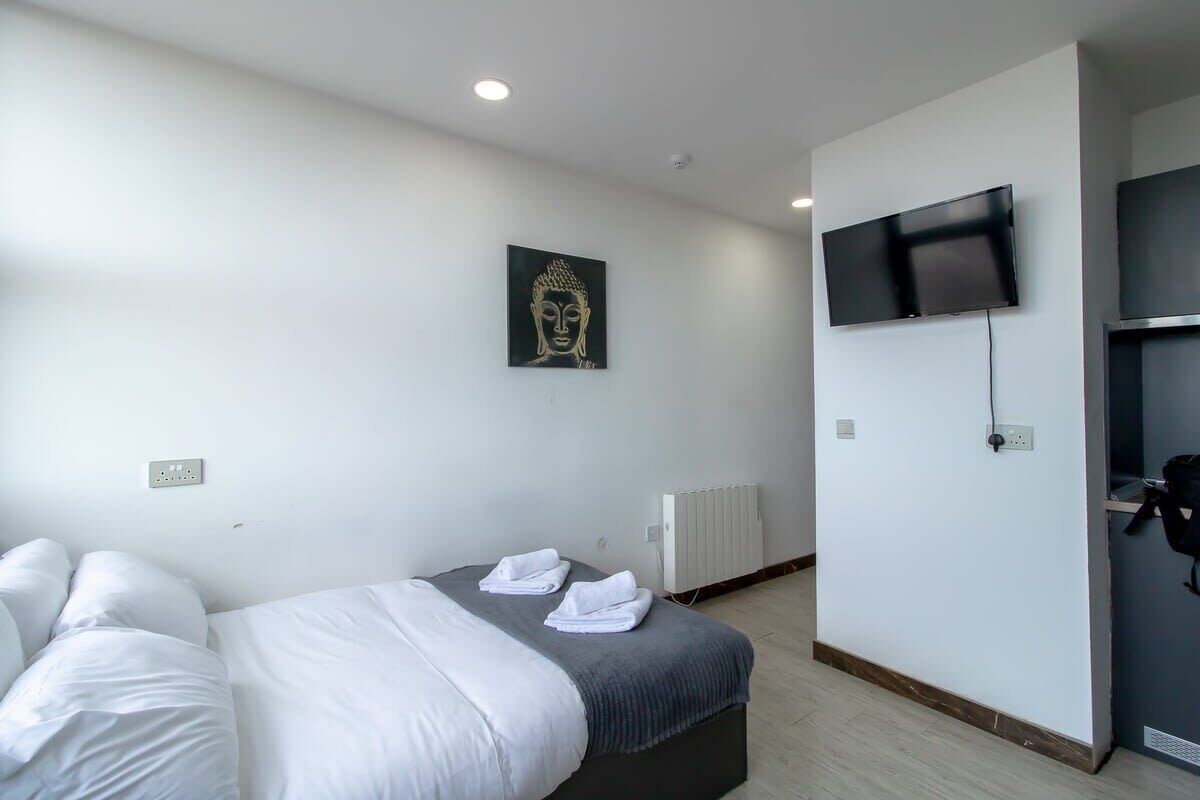 Desk, iron/ironing board, bed sheets