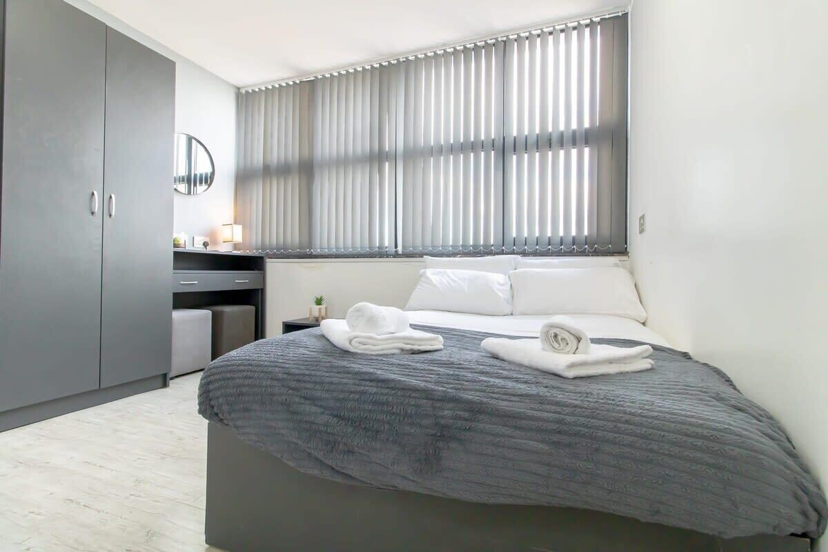 Desk, iron/ironing board, bed sheets