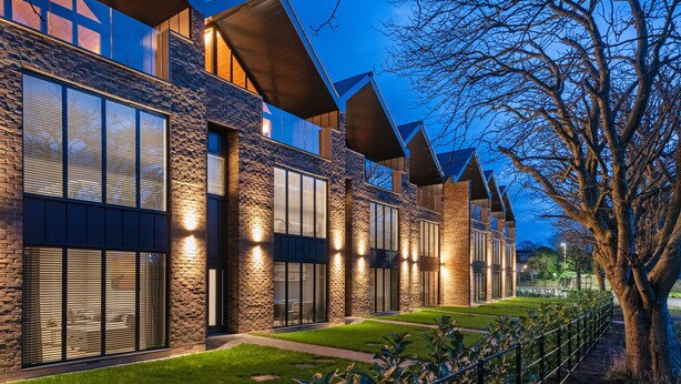 A modern building with a stone facade, large windows, and a well-maintained lawn. - Stylish Northumberland retreat in the heart of Amble (Amble)