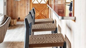 Un interior de madera con una zona de comedor que incluye una mesa larga y sillas.