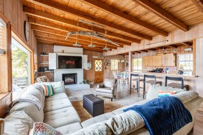 Cozy living area with a fireplace, sectional sofa, and dining space.