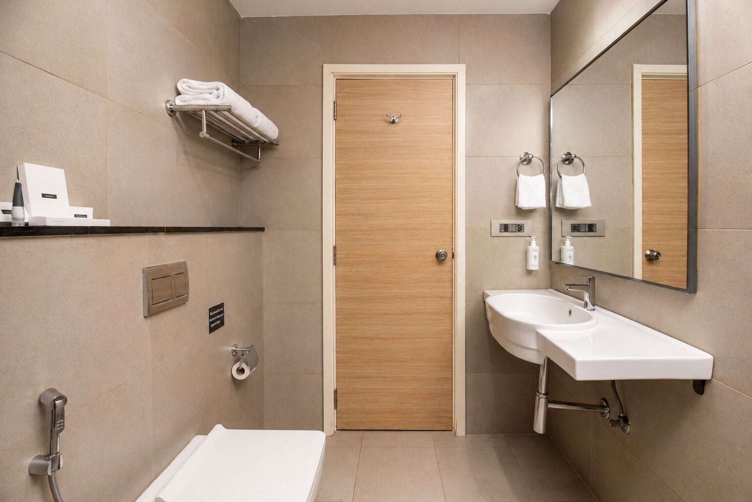 A modern bathroom with a bathtub, a sink, a toilet, and a shower.