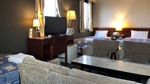 A hotel room with two beds, a desk with a television, a coffee maker, and two lamps. - Hotel 28 Hiroshima (Hiroshima)
