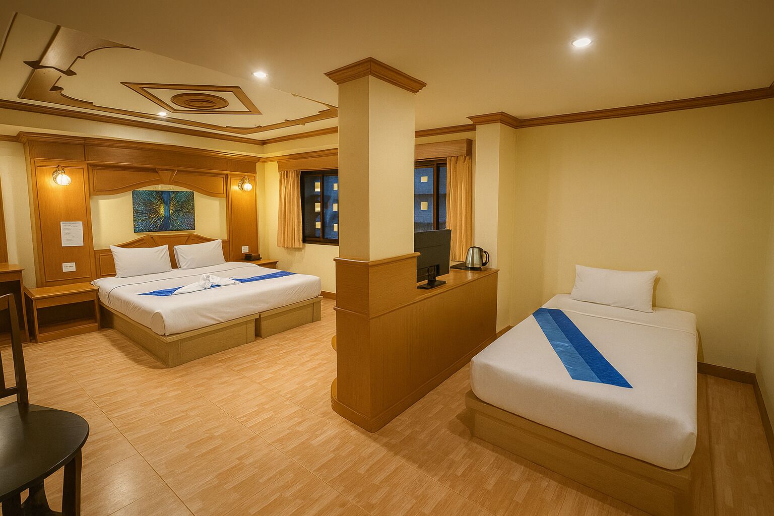 A hotel room with two beds, a desk, and a minibar.