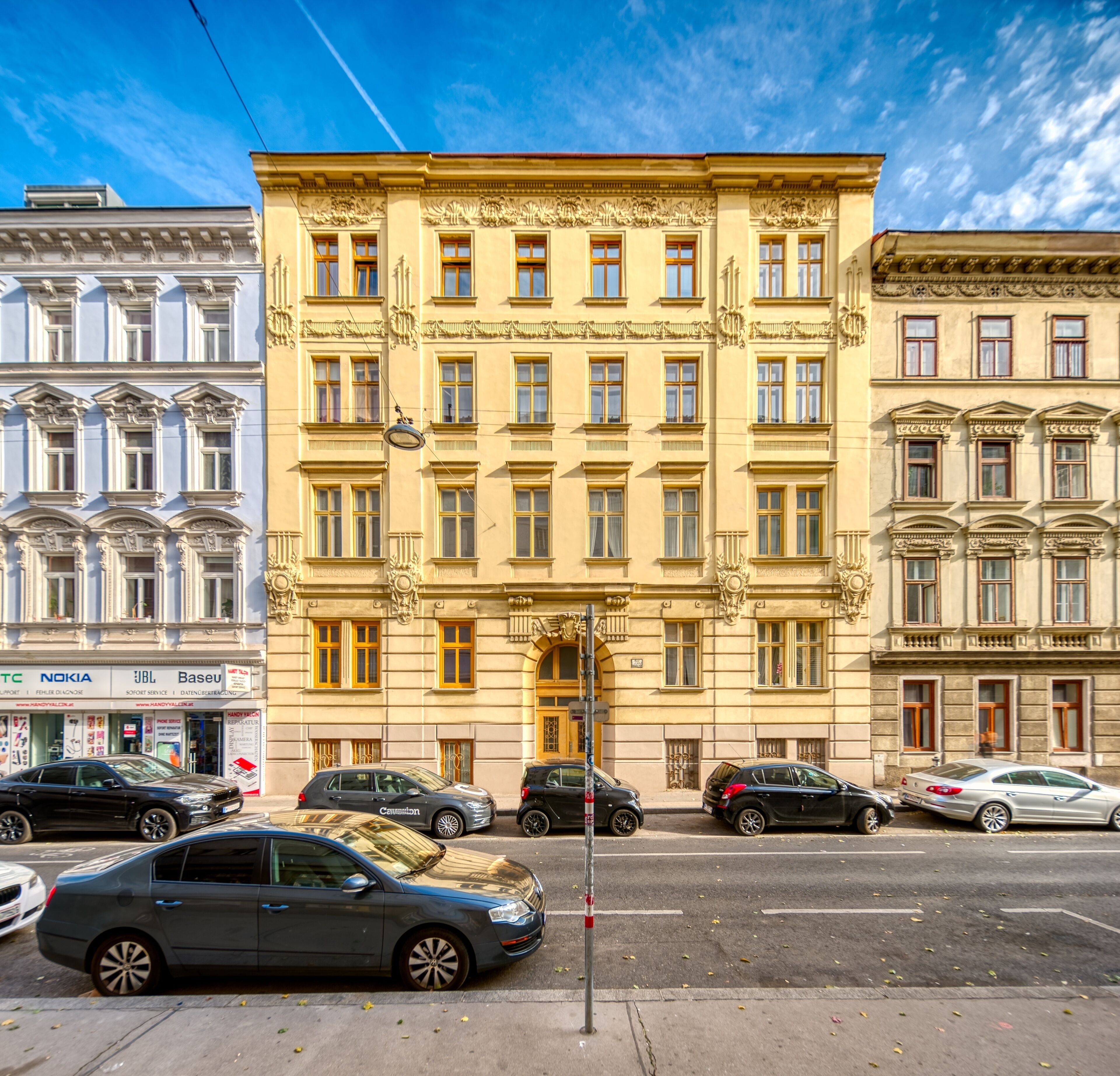 A multi-story building with a classic architectural style, featuring ornate window frames and decorative moldings.