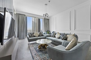 Deluxe Apartment | Living area | 58-inch Smart TV with cable channels - WelHome - Stunning Apartment With Sea Views in Creek Harbour (Dubai)