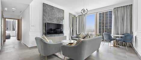 Deluxe Apartment | Living area | 58-inch Smart TV with cable channels