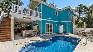 A two-story house with a swimming pool, a covered patio, and a deck with outdoor furniture. - Irie: New Build | Private Pool | Hot Tub (Corolla)