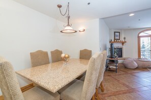 Enjoy meals with friends and family at this dining area, featuring a spacious table and comfortable seating for six.