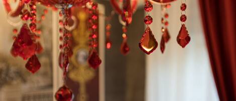 A close-up of a chandelier with red crystal decorations.