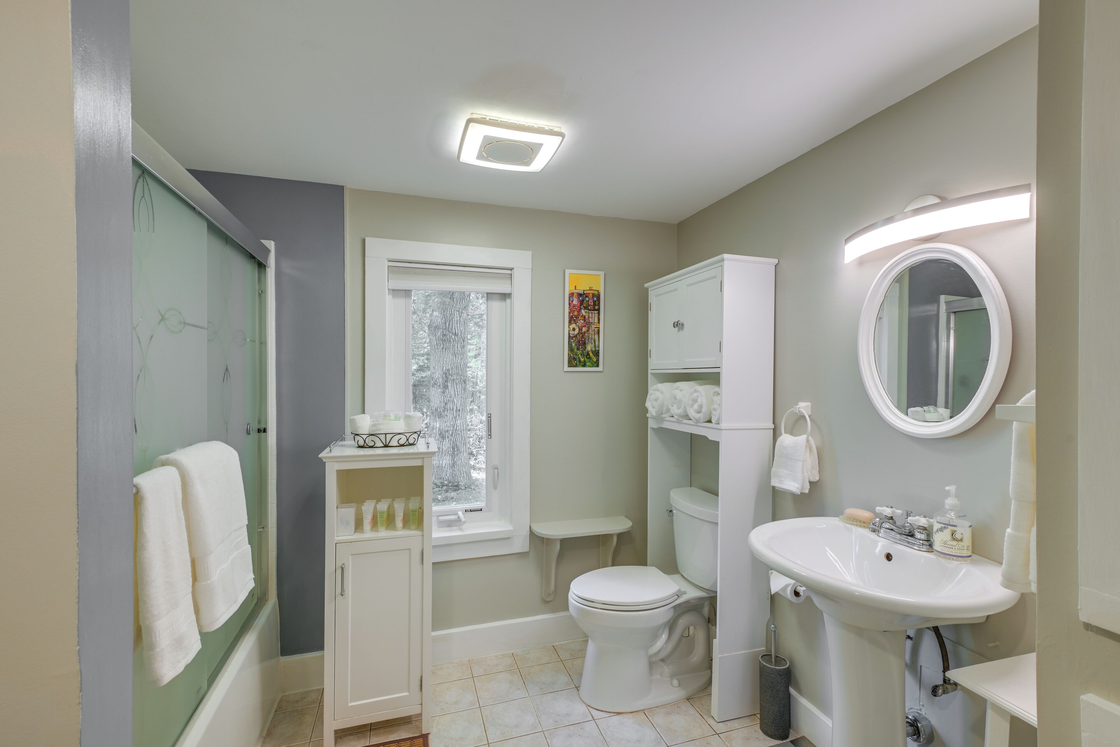 A bathroom with a toilet, sink, and shower.