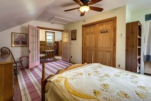 Relax in this serene bedroom with a large bed and comfortable seating area.