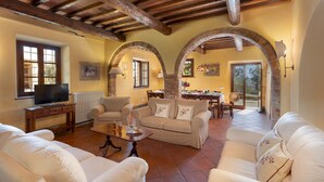 Amplia sala de estar con chimenea, asientos cómodos y comedor con vistas.