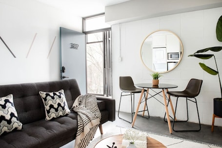 TV. The Layla – Walkable Downtown Apartment + Rooftop