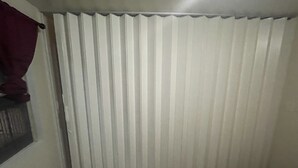 A room with a window, a radiator, and a patterned rug.