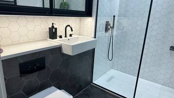 Apartment, 1 Queen Bed | Bathroom | Shower, free toiletries, hair dryer, towels