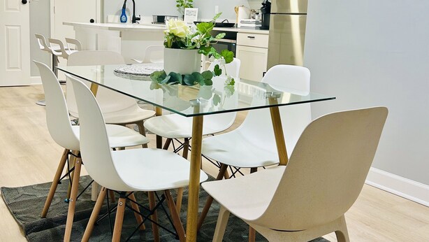 A modern kitchen with white cabinets, a stainless steel refrigerator, and a built-in oven.