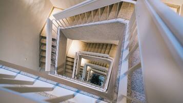 A multi-level interior with a central staircase surrounded by walls and a ceiling.
