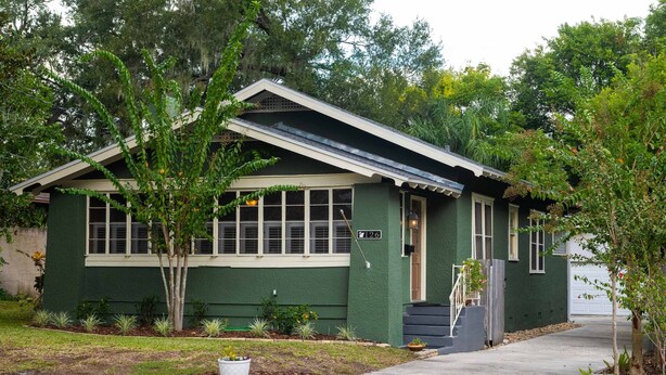 A green house with a small porch, a garage, and a well-maintained lawn. - New Listing! - Bungalow on Belmar, 4 Bed Sleeps 6. Walk to Lake Hollingsworth!  (Lakeland)