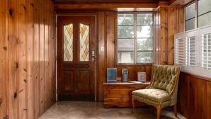 A wooden interior with a door, a window, a desk, and a chair. - New Listing! - Bungalow on Belmar, 4 Bed Sleeps 6. Walk to Lake Hollingsworth!  (Lakeland)