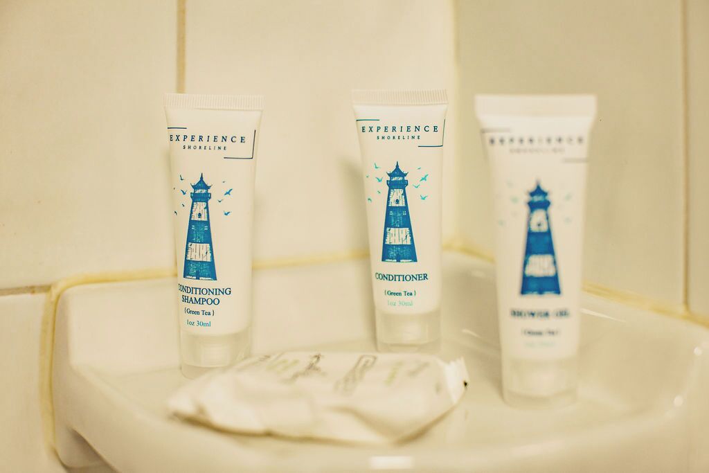 Three toiletry items on a white sink.
