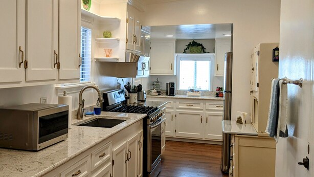 A spacious kitchen with white cabinetry, a built-in oven, and a microwave. - Turn-of-the-Century Gem! The Painted Lady.   (Bisbee)