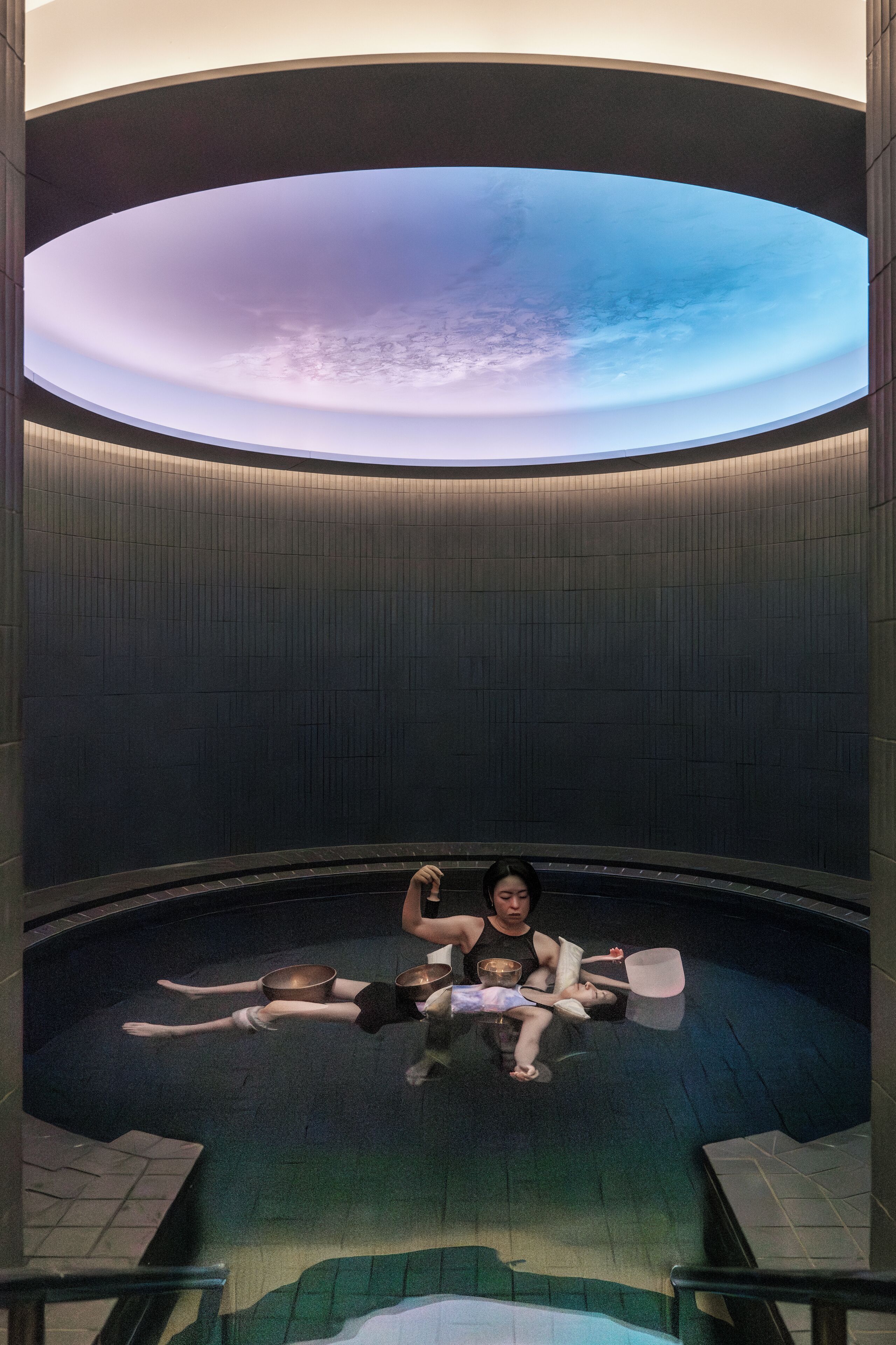 A circular room with a large, illuminated globe at the center.