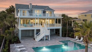 A two-story house with a pool and outdoor seating. - Seascapes 714 Ocean Blvd. Charming, Ocean Front, Private Pool (Isle Of Palms)