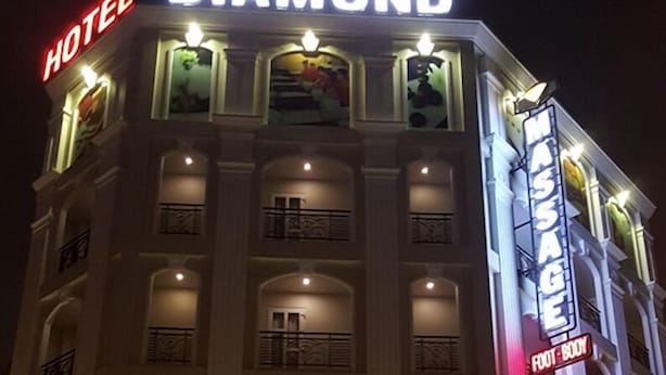 A hotel named 'Diamond' with a prominent sign, multiple balconies, and a well-lit entrance. - Diamond Hotel (Ho Chi Minh City)