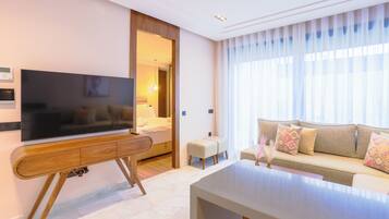 Superior Apartment, 1 Queen Bed | Living area | 50-inch flat-screen TV with satellite channels, TV, pay movies