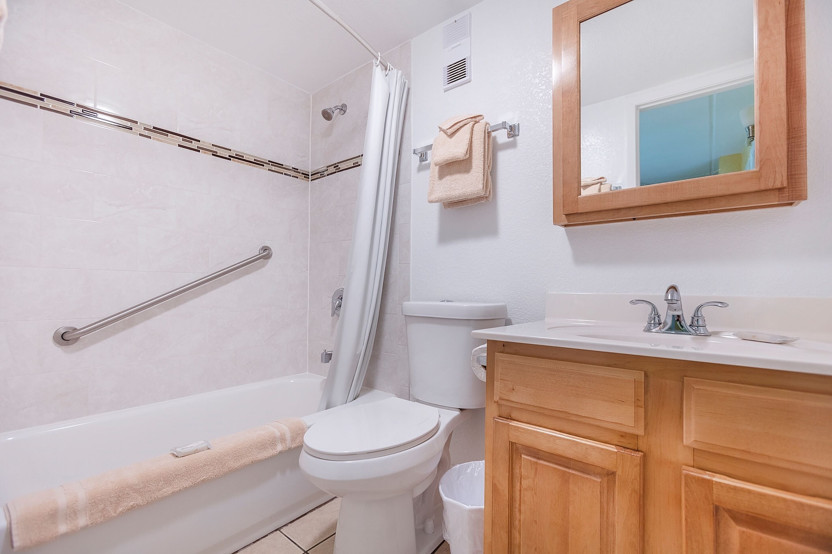 A bathroom with a bathtub, toilet, and sink.