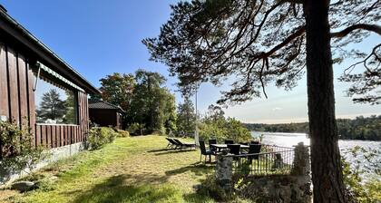Waterfront villa in Långstrandsudd: Panoramic views, private sauna, and dock