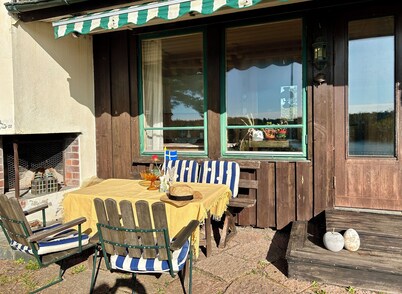 Waterfront villa in Långstrandsudd: Panoramic views, private sauna, and dock