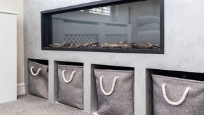A modern interior with a fireplace, a framed mirror, and storage baskets with rope handles. - New Listing Special Discount! (Greater Manchester)