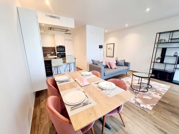 A modern apartment with a dining area, kitchen, and living space. - Luxury 2 bedrooms with Parking&Terrace (Luxembourg City)