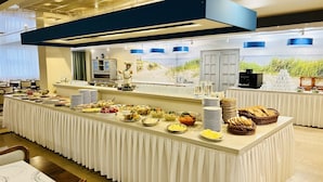 A buffet setup with various food items and a chef figure. - Alga Baltic Resort (Swinoujscie)