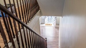 A wooden staircase leading to a landing with a doormat. - Modern Modest Design  Newburgh, Beacon, Westpoint  2nd. FL Apt. (Newburgh)