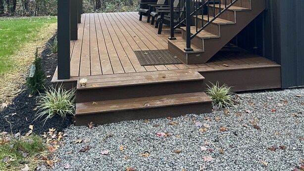 A covered outdoor deck with a staircase leading to a building. - Cozy private getaway built for couples to reconnect !!  (West Union)